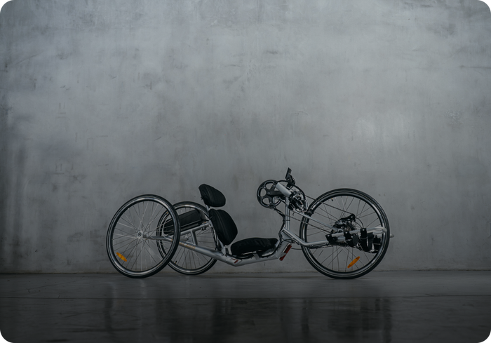 Close-up of a handcycle frame on a road during body measurement assessment session