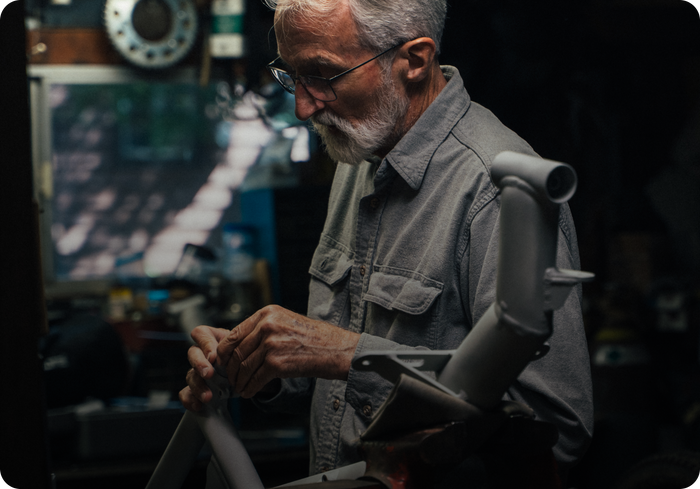 Technician analyzing handcycle components and performing position analysis adjustments