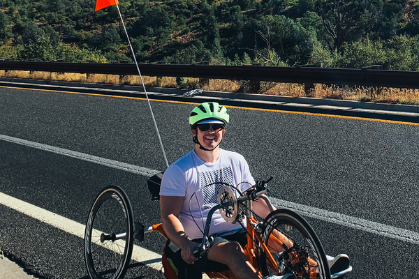 Person with neurological condition using an adaptive handcycle on a road